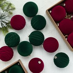 christmas ornaments are arranged in boxes on a table