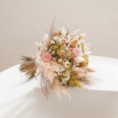 a bridal bouquet sitting on top of a white table