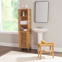 a wooden cabinet sitting next to a white sink