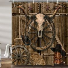 a shower curtain with a cow skull and cowboy hat on it's head next to hay bales