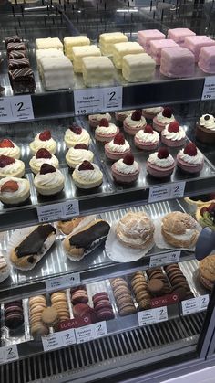 a display case filled with lots of different types of desserts