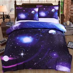 a bed covered in purple and blue space themed comforter sets with stars on them