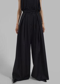 Color: Black Lightweight woven fabric  Relaxed silhouette Wide leg Elastic back
 Inverted pleat detail Belt loops with detachable tie string Slant hip pockets Front button closure
 Zip fly Unlined 70% Polyester 30% Rayon
 Dry Clean
 By The Frankie Shop. Imported Black Wide-leg Pants With Tie Waist, Black Wide Leg Pants With Tie Waist, Elegant Belted Cotton Pants, Elegant Black Bottoms With Tie Waist, Black Cotton Bottoms With Tie Waist, Chic Black Tie Waist Pants, Chic Black Pants With Tie Waist, Black Cotton Belted Bottoms, Black Belted Cotton Bottoms