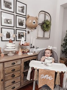 a baby sitting in a highchair with a cake on it's plate