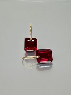 Beautiful red ruby earrings in Brilliant drops. The faceted rectangle drops have an amazing dark wine red color and are attached to 24K Gold Vermeil/ 14K SOLID GOD  ear wires.  The earrings are elegant, minimalist, and perfect to go with any outfit.   A truly gorgeous pair of earrings. When 14K SOLID GOLD ear wires are being used, the ear wire ends are hand-stamped as proof of being 14K solid gold. In addition, extra work was done at the end of the ear wires to prevent any sort of pain or injury Red Ruby Earrings, Jewelry Ruby, Diamond Bracelet Design, Citrine Jewelry, Birthstone Earrings, Ruby Earrings, Garnet Earrings, Jewelry Christmas, Types Of Gemstones