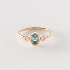 𝟏𝟒𝐤 𝐒𝐨𝐥𝐢𝐝 𝐆𝐨𝐥𝐝 𝐎𝐯𝐚𝐥 𝐓𝐞𝐚𝐥 𝐒𝐚𝐩𝐩𝐡𝐢𝐫𝐞 𝐑𝐢𝐧𝐠 The Diamond Teal Sapphire Bezel Ring is a stunning piece of handmade jewelry crafted in 14k solid gold. Featuring a small oval blue sapphire in a delicate bezel setting, this ring is a beautiful and unique statement of elegance. The addition of diamonds adds a touch of sparkle and sophistication to the design. Perfect as a promise ring or a dainty accessory, this handmade piece is a thoughtful and stylish gift for someone spe Aquamarine And Citrine Ring, Sapphire Ring White Gold, 14k Gold Oval Topaz Ring With Center Stone, Oval Topaz Center Stone Ring In 14k Gold, Oval Sapphire Diamond Ring With Bezel Setting, Oval Topaz Ring With Bezel Setting For Anniversary, Oval 14k Gold Rings With Bezel Setting, Oval Topaz Ring In 14k Gold With Bezel Setting, Oval Sapphire Ring With Halo Setting In 14k Gold