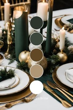 the table is set with gold and green plates, candles, and evergreen greenery