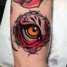 a close up of a person's arm with tattoos on it and an eye in the center