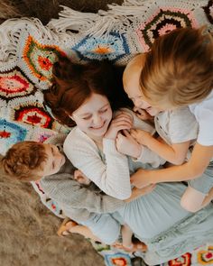 two young children are playing with their mother