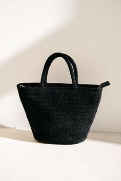 NEW! The Onyx Suede Tote is this season's must-have bag to take you through winter. Crafted from luxurious black suede, the hand woven design exudes sophistication and timeless elegance. The top zip closure and crossbody strap provide convenience and the interior pockets offer extra security and organization. Color: Onyx (Black) Handwoven suede leather Includes crossbody strap. Interior pockets Top zip closure Gold hardware Dimensions Length: 12 in / 30 cm Height with handle: 13 in / 33 cm Heigh Luxury Suede Bag With Zipper Closure, Luxury Black Suede Bags, Chic Suede Bag With Zipper Closure, Black Suede Bags For Daily Use, Black Suede Crossbody Bag, Suede Bag, Suede Tote, Woven Design, Pocket Top