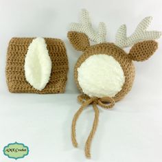 a crocheted deer hat and diaper cover are sitting next to each other