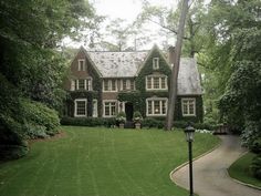 a house in the middle of a lush green yard