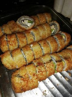 several pieces of food sitting on top of a metal tray