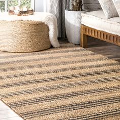 a living room area with a large rug on the floor