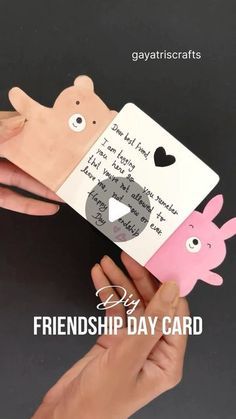 someone is holding up a card with an image of a bear and pig on it