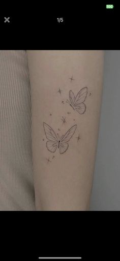 a woman's arm with two butterflies on the left side of her body, and stars in the background