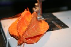 an orange piece of cloth sitting on top of a white table