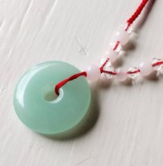 Ice jade pale green donut disc red silk cord necklace Beautiful, untreated, undyed, natural jade stone 1 inch disc Adjustable silk cord to 30 inches Adjustable Round Jade Necklaces, Green Donut, Silk Cord Necklace, Pottery Patterns, Ice Star, Silk Cord, Tiny Hand, Natural Jade, Jade Stone