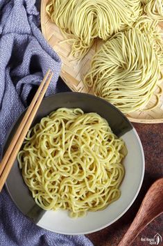 a bowl of noodles with chopsticks next to it