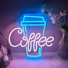 a neon sign that says coffee next to a vase with flowers