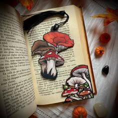 an open book with two mushrooms on it