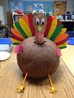 a fake turkey sitting on top of a wooden table