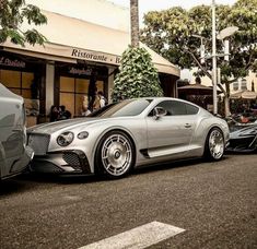 a silver sports car parked in front of a building