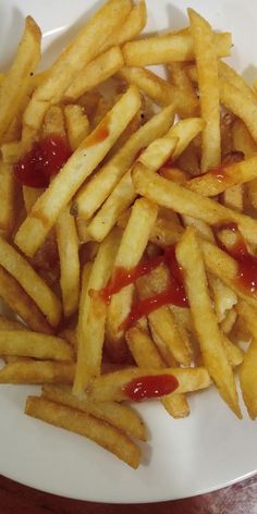 french fries with ketchup on a white plate