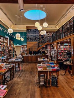 the inside of a library with lots of books on shelves and tables in front of them