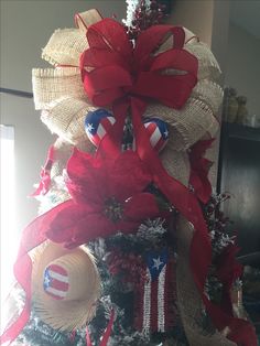 a decorated christmas tree with red, white and blue decorations on it's top