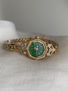 Welcome to AffordLuxe Watches! We're delighted to have you here in our store 🤩 Elevate your elegance with this stunning vintage-inspired women's watch, featuring a unique hexagonal green dial that adds a bold touch to your style. The gold-tone case and intricate bracelet design are adorned with sparkling crystal accents, enhancing the luxurious appeal of this timepiece. ★Material: - Stainless Steel  - Copper  - Glass ★Dimensions: - Case Height: 7mm - Case Width: 20,5mm - Case Length: 20,5mm - Band Width: 5,5mm ★Delivery:   To ensure a smooth and successful shopping experience, please provide us with your exact shipping address and phone number. This will help us deliver your order promptly and stay in touch with you regarding any updates. ★Care Instructions: - Avoid wearing the watch in t Womens Gold Jewelry, Watch Layering, Womens Vintage Watches, Dainty Wrist Watch, Old Money Gifts For Him, Vintage Gold Womens Watch, Elegant Watches Women Classy, Womens Gold Watch, Wife Gifts