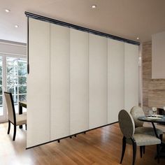 a dining room with sliding glass doors and chairs