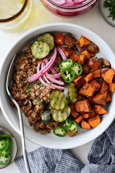 a white bowl filled with meat and veggies