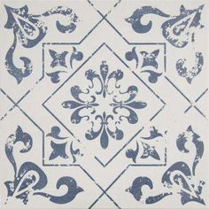 a blue and white tile with an ornate design