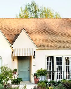 a white house with a blue front door