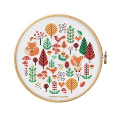 a cross stitch pattern with different types of trees and animals on it's side