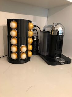 two coffee makers are sitting on the counter next to each other and one is filled with eggs