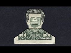 an origami man made out of one hundred dollar bills on a black background