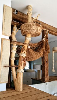 a wooden structure made out of wood sticks and rope with various items hanging from it