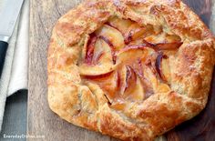 an apple pie on a cutting board next to a knife