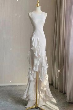 a dress on a mannequin in front of curtains