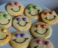 some cookies with smiley faces and candy on them