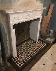 an old fireplace is being remodeled with new paint and flooring in the process of remodeling