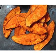 several pieces of cooked sweet potato on a plate with some seasoning in the background