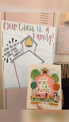 a child's artwork is displayed in front of a bookcase with books on it