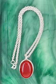 This carnelian pendant is bezel set on a cable chain. And this smooth, polished gemstone in burnished red makes a nice statement in a strapless style, office attire, t-shirt or sweater.

Size: The pendant length is 1", width is 11/16", gemstone is 25 x 18 millimeters, chain length 14”, chain width is 2.8 millimeters Gift Oval Cabochon Necklace With Polished Finish, Red Polished Round Pendant Necklace, Red Polished Pendant Necklaces, Red Carnelian Oval Necklace, Red Oval Pendant Necklace With Polished Finish, Red Pendant Necklace With Polished Finish, Red Oval Carnelian Necklace, Oval Red Necklace With Polished Finish, Red Carnelian Oval Pendant Necklaces