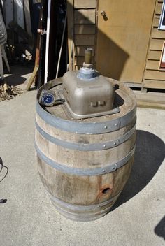 a wooden barrel sitting on top of a cement floor