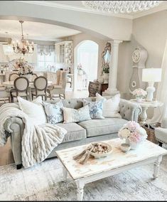 a living room filled with furniture and a chandelier