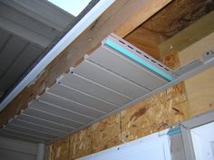 an unfinished room with a skylight in the ceiling