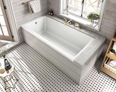 a white bath tub sitting next to a window